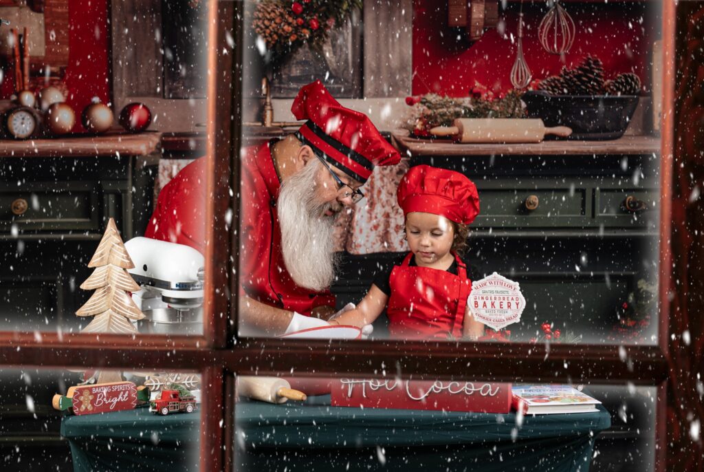 santa decorating a christmas cookie with a child