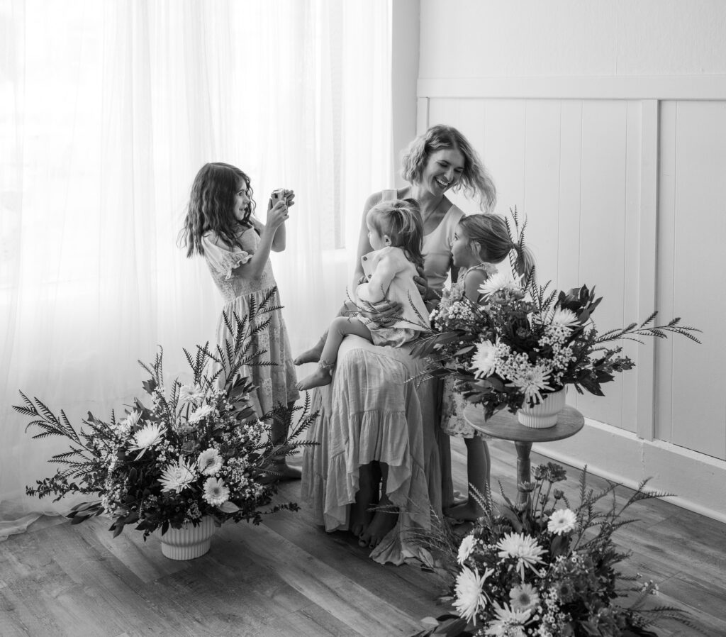 Mother and 3 daughters posing for photos at Mother's Day Minis Indianapolis with Bri Elizabeth Photography in Danville