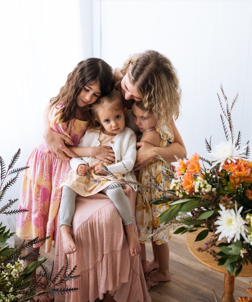 Mother and 3 daughters posing for photos at Mother's Day Minis Indianapolis with Bri Elizabeth Photography in Danville
