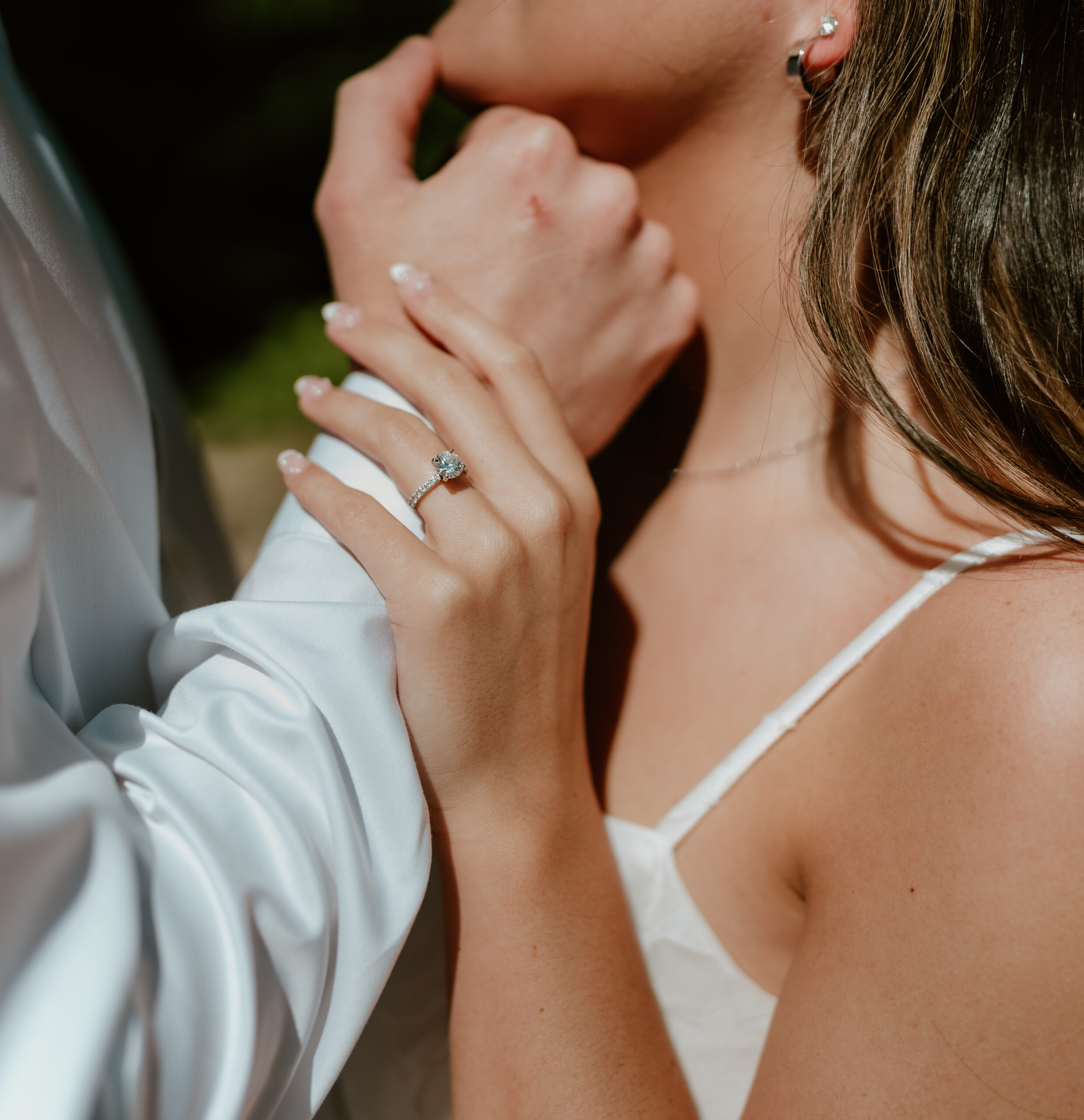 Couple posing at Avon Gardens for their engagement session showing off the engagement ring