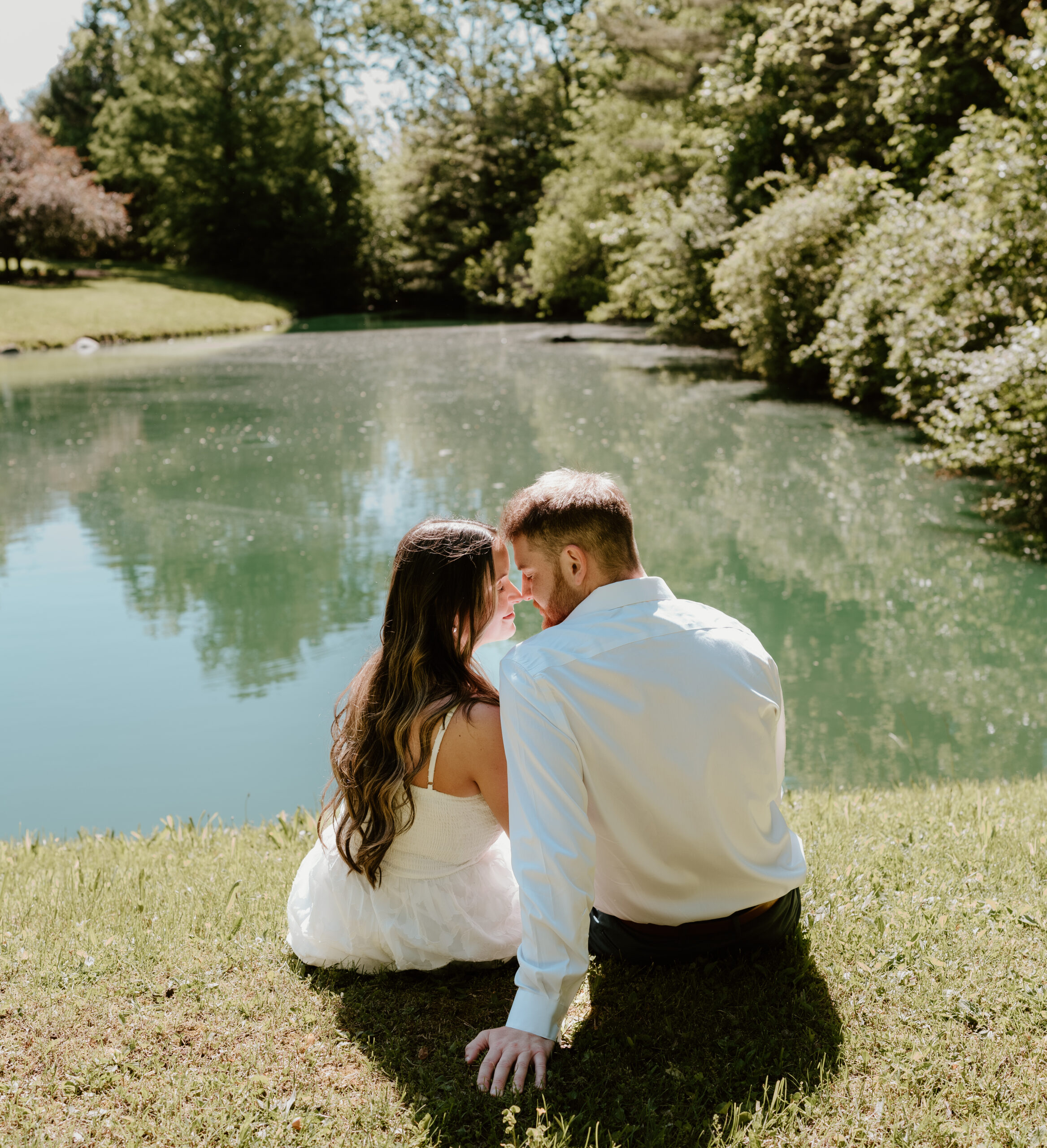 Couple posing for engagement photos at Avon Gardens