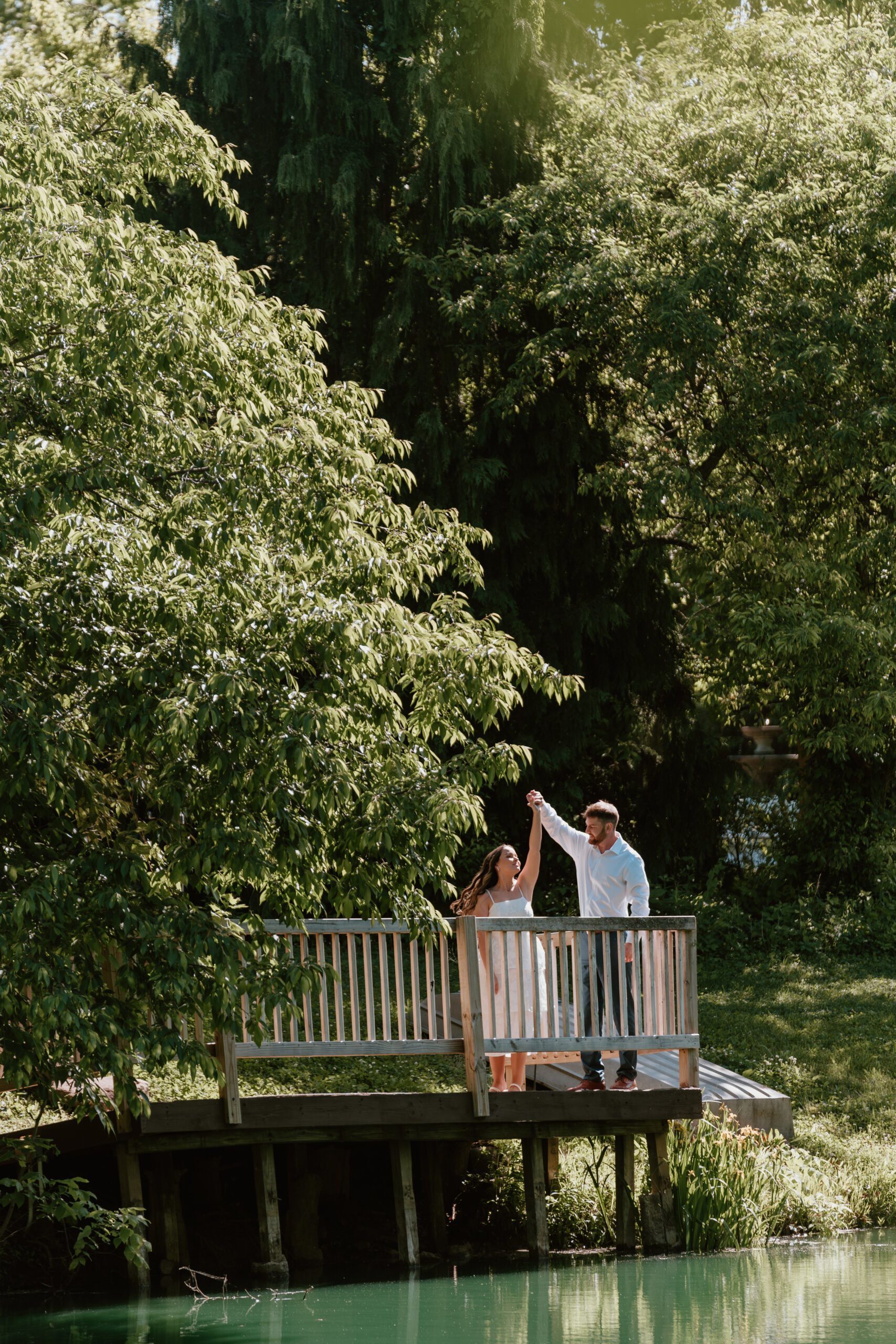 Couple posing for engagement photos at Avon Gardens